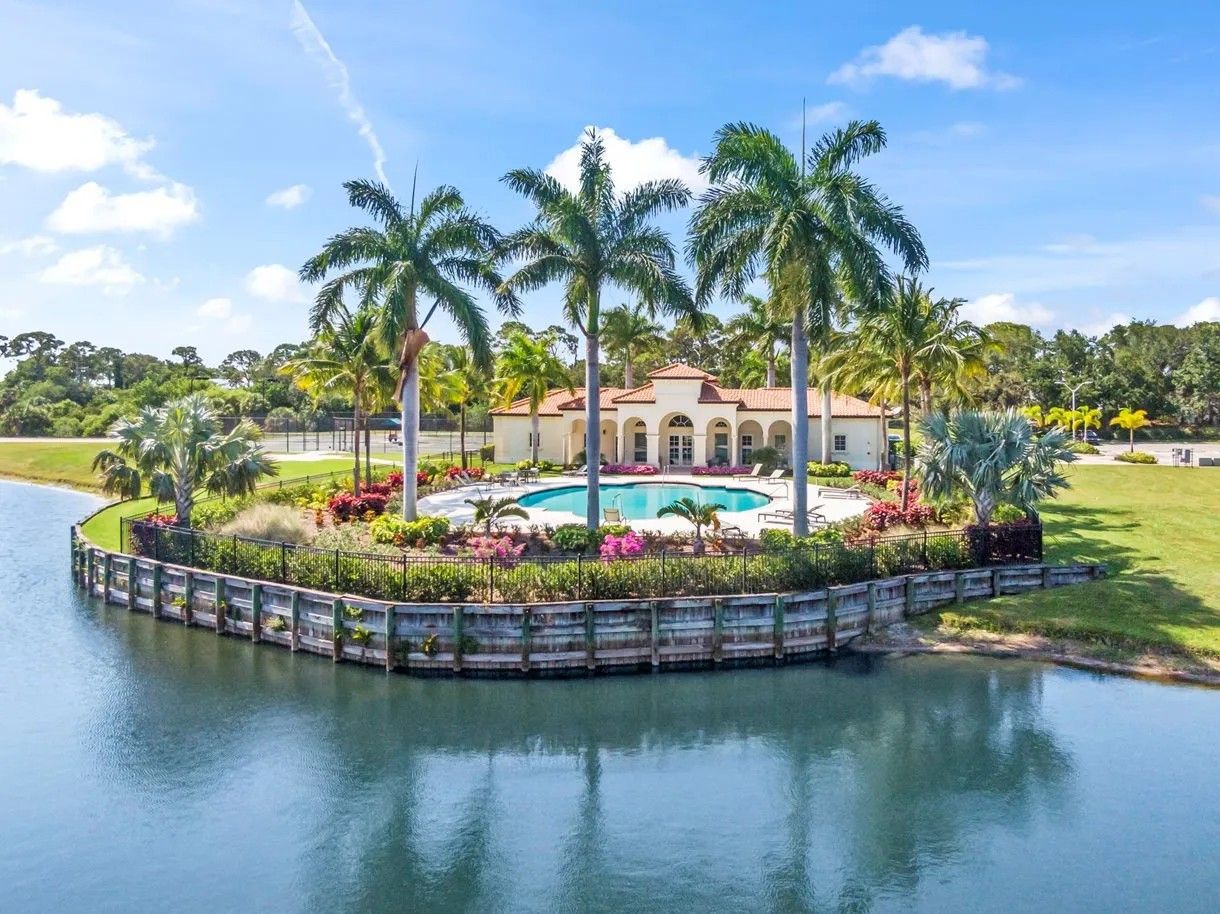 Rivella Club and lakeside pool surrounded by landscaped grounds in Port St. Lucie