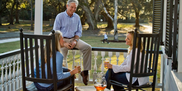 people sitting on porch drinking sweet tea
