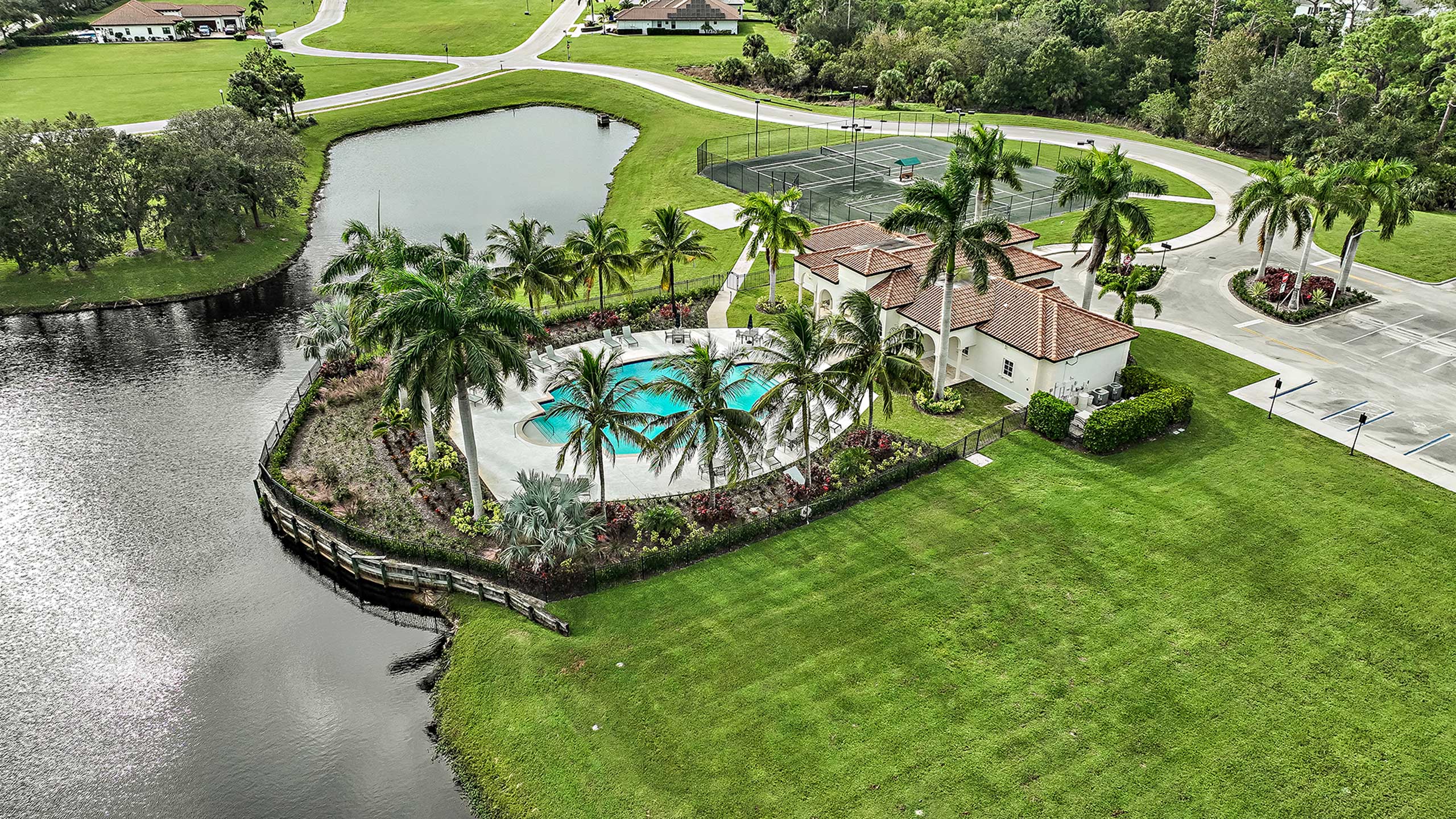 Rivella lakeside clubhouse and pool with palm trees