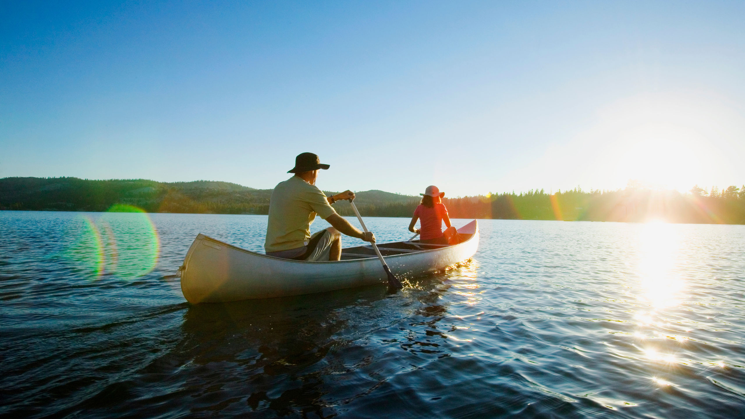 Residents canoeing on a calm lake at The Ponds