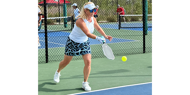 Woman Hitting Pickleball