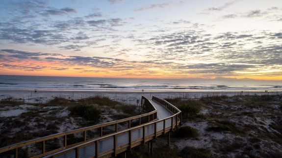 Walking bridge on beach overlooking ocean
