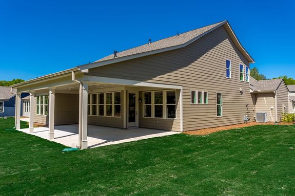 maple model home rear exterior with covered porch